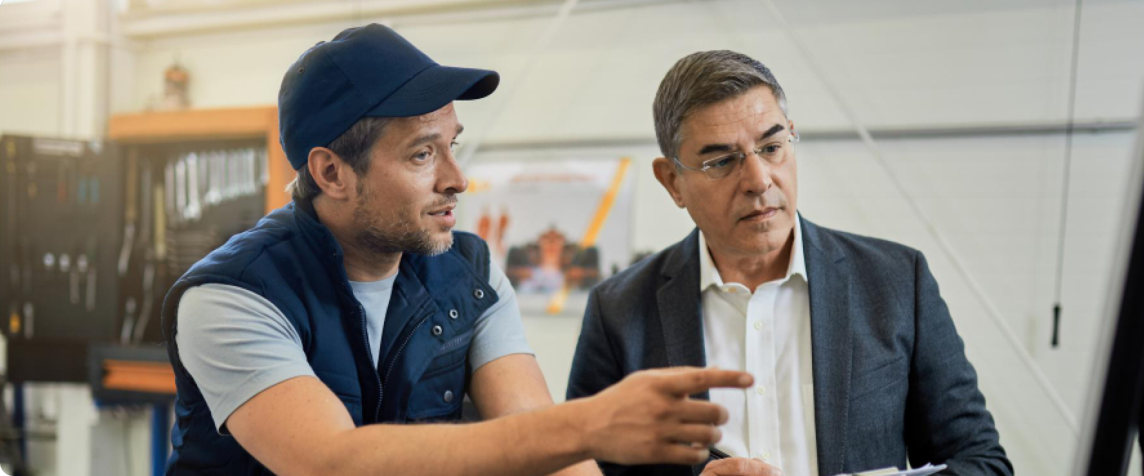 A technician and a manager reviewing work on site